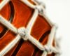 Close up of basketball in net.