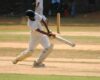 A cricket player hitting the ball