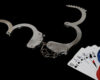 Open handcuffs and casino chips and playing cards