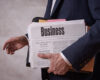 businessman holding newspaper