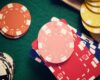 Casino chips stacking on a green felt.
